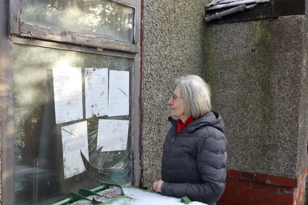 Mary Thomas is pictured outside a house on Ruskin Street that has been derelict for over 15 years